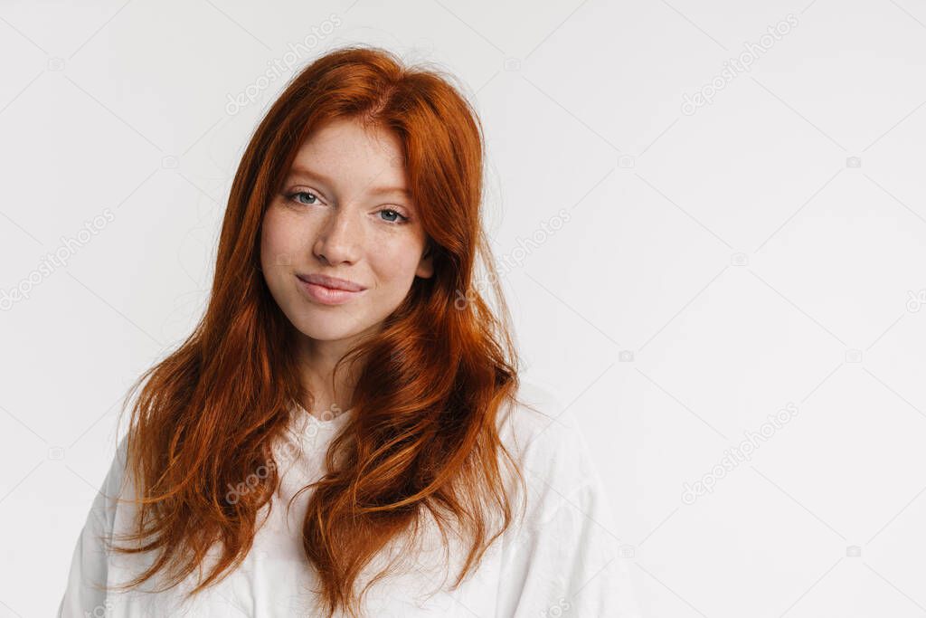Ginger beautiful happy girl posing and smiling at camera isolated over white background