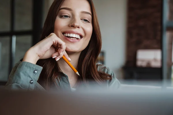 Mulher Sorridente Bonita Trabalhando Com Laptop Enquanto Sentado Mesa Dentro — Fotografia de Stock