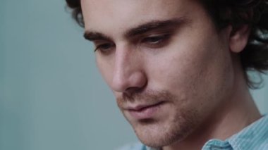 Mutlu bir iş adamının yakın plan görüntüsü ofiste otururken akıllı telefonunu kullanmasıdır.