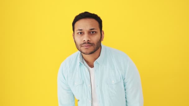Attractive Indian Man Peeping Something Standing Isolated Yellow Background Studio — Stock Video