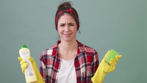 Displeased Cleaner Woman Holding Cleaner Equipment Standing Isolated Green Background — Stock Video