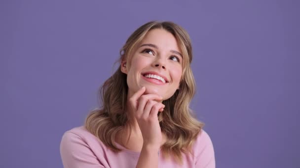 Усміхнена Жінка Мріє Про Щось Стоїть Ізольовано Фіолетовому Тлі — стокове відео