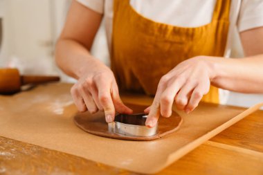 Kafkasyalı pasta şefi kadın rahat mutfakta Noel kurabiyesi yapıyor.