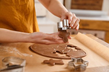 Kafkasyalı pasta şefi kadın rahat mutfakta Noel kurabiyesi yapıyor.