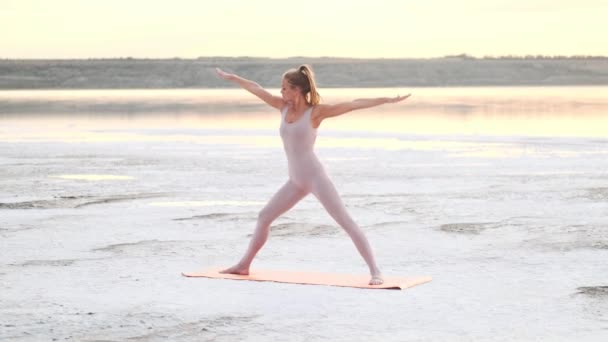 Calm Blonde Woman Doing Yoga Exercises Standing Mat Morning Lake — Stockvideo