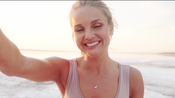 Smiling Young Blonde Woman Taking Selfie Photo While Sending Air — Stockvideo