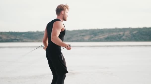 Strong Young Sportsman Jumping Rope While Training Outdoors Using Special — Αρχείο Βίντεο