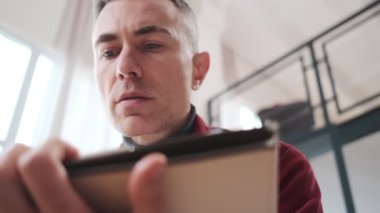 A close-up view of a mature man thoughtfully reading documents while sitting in a room