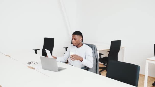 Handsome Black Guy Earbuds Working Paper Documents Sitting Office — Stock videók