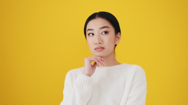 Good Looking Asian Woman Thinking Something Standing Isolated Yellow Wall — Stock Video