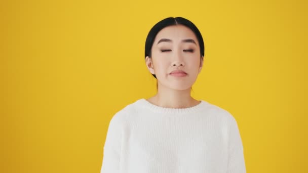 Confused Asian Woman Raising Her Hands Standing Isolated Yellow Wall — Stock Video