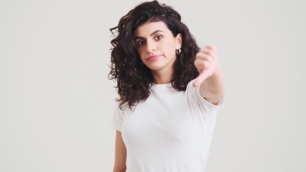 Upset Woman Showing Thumb Camera While Standing Studio — Αρχείο Βίντεο