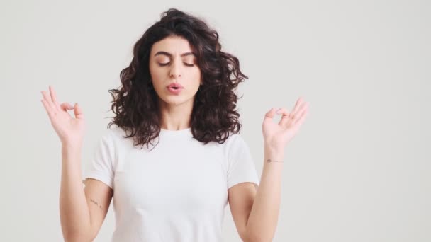 Woman Meditating Closed Eyes Making Deep Breaths While Standing Studio — Vídeo de Stock