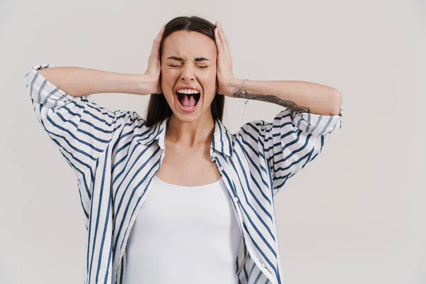 Irriterad Vacker Brunett Flicka Skriker Och Täcker Öronen Isolerade Över — Stockfoto