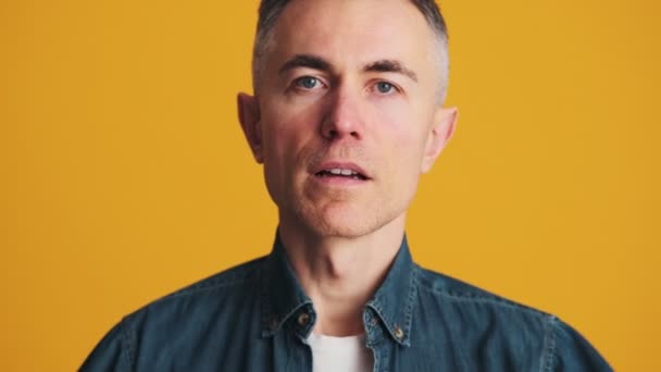 Portrait Smiling Mature Man Correcting His Appearance While Standing Yellow — Αρχείο Βίντεο