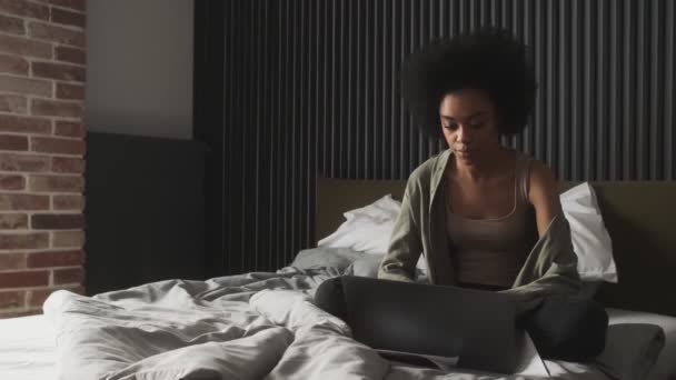 Black Smiling Woman Sitting Bed Laptop Looking His Screen Room — Stockvideo