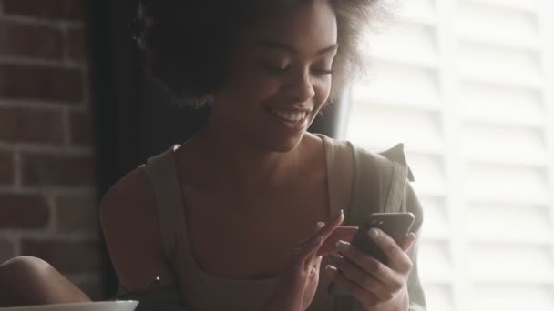 Happy Woman Flipping Something Phone While Sitting Bright Room — Stock videók