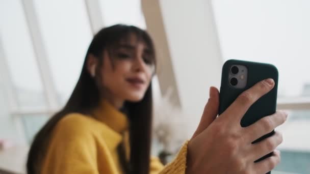 Smiling Woman Headphones Sweater Making Selfie Phone While Sitting Window — Stock Video