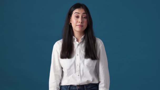 Confused Korean Woman Raising Her Hands Standing Isolated Blue Wall — Stock Video