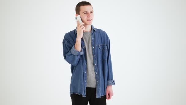 Smiling Man Denim Shirt Talking Phone While Standing Gray Studio — Stock Video