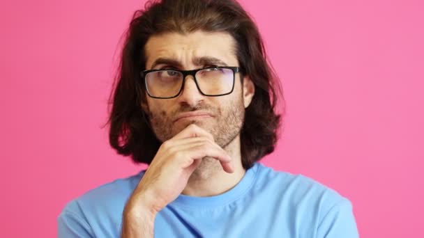 Портрет Задумчивого Человека Очках Думающего Подносит Руку Лицу Розовой Студии — стоковое видео