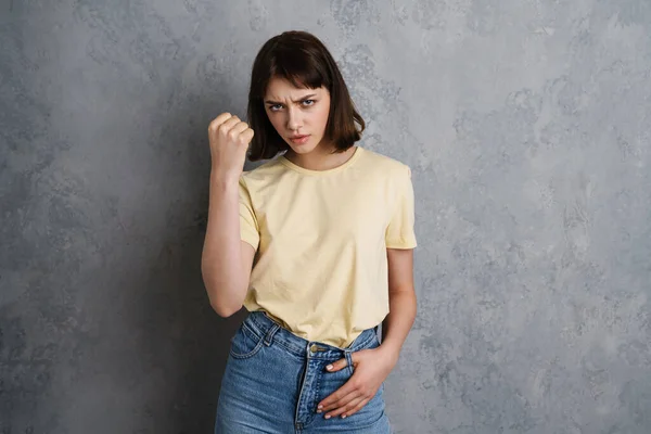 Angry Mad Young Woman Showing Fist Camera Isolated Gray Background — Stock Photo, Image