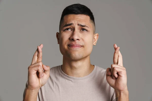 Unhappy Handsome Guy Posing Fingers Crossed Good Luck Isolated Grey — Stock Photo, Image