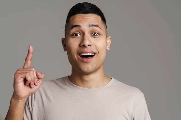 Brunette Excited Man Looking Camera Pointing Finger Upward Isolated Grey — Stock Photo, Image