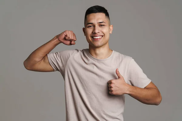 Brunette Happy Man Showing His Bicep Thumb Camera Isolated Grey — Stock Photo, Image