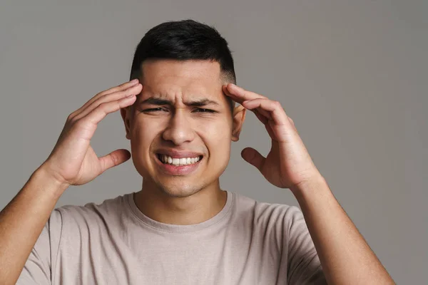 Brunette Unhappy Man Headache Frowning Holding His Head Isolated Grey — Stock Photo, Image