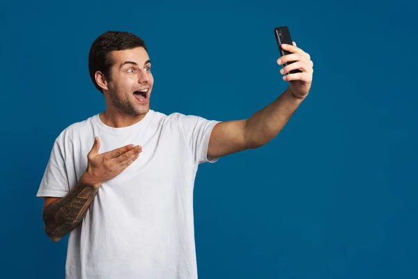 Delighted Handsome Guy Taking Selfie Mobile Phone Isolated Blue Background — Stock Photo, Image