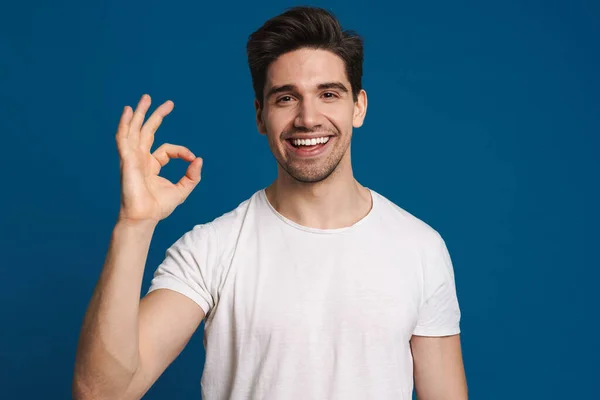 Happy Unshaven Guy Smiling Showing Sign Camera Isolated Blue Background — Stock Photo, Image
