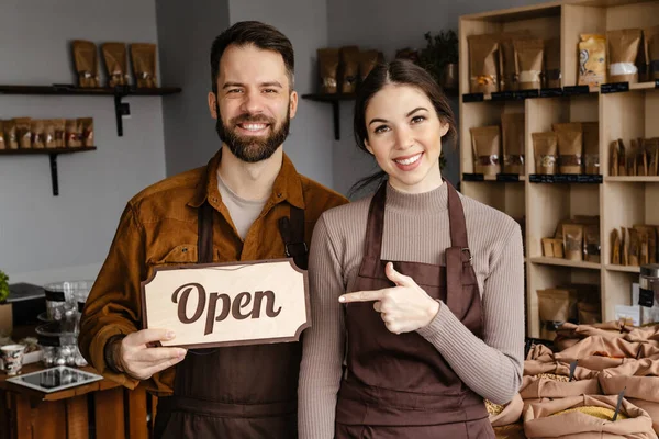 Smiling Sellers Man Woman Aprons Showing Open Sign Board Local — Stock Photo, Image