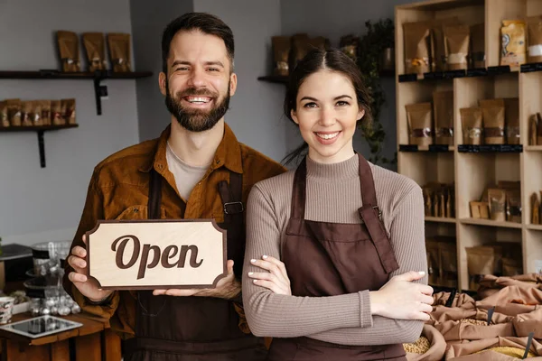 Smiling Sellers Man Woman Aprons Showing Open Sign Board Local — Stock Photo, Image