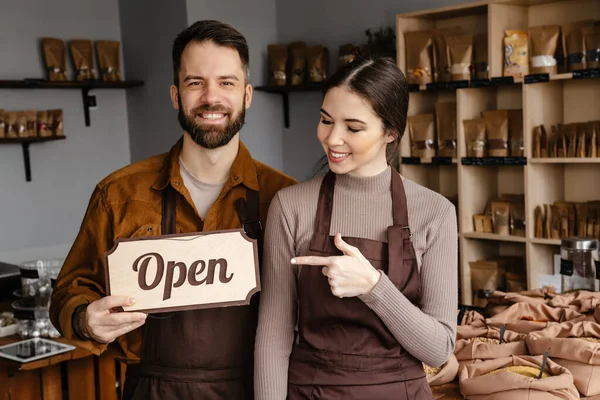 Smiling Sellers Man Woman Aprons Showing Open Sign Board Local — Stock Photo, Image