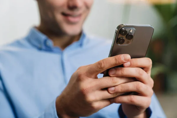 Smiling Handsome Young Entrepreneur Using Mobile Phone While Sitting Modern — Stock Photo, Image