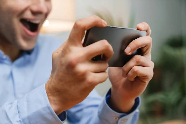 Happy Young Businessman Using Smartphone Celebrating Success Workplace — Stock Photo, Image