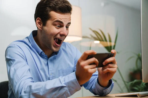 Gelukkige Jonge Zakenman Met Smartphone Het Vieren Van Succes Werkplek — Stockfoto