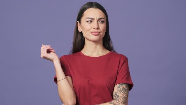 Disappointed Young Woman Looking Camera Standing Isolated Purple Background Studio — Stock Video