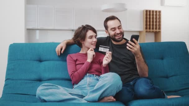 Positive Couple Man Woman Using Smartphones While Transferring Money Using — Stock Video