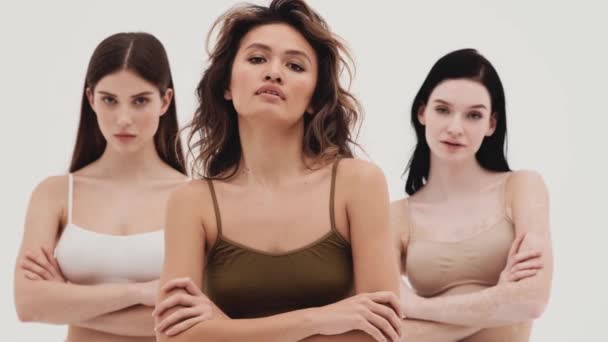 Three Concentrated Girls Looking Camera Crossing Arms While Standing White — Stock Video