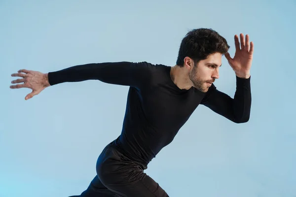 Young Athletic Sportsman Running While Working Out Isolated Blue Background — Stock Photo, Image