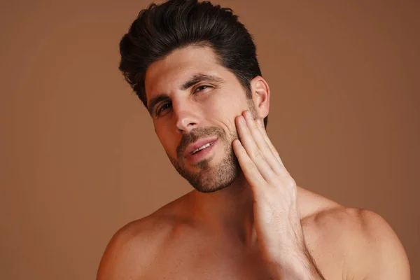 Young Masculine Man Looking Rubbing His Face Isolated Beige Background — 스톡 사진