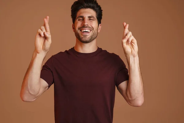 Joyful Masculine Man Posing Fingers Crossed Good Luck Isolated Beige — Stock Photo, Image