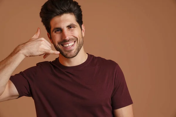 Happy Masculine Man Smiling While Showing Handset Gesture Isolated Beige — Stock Photo, Image