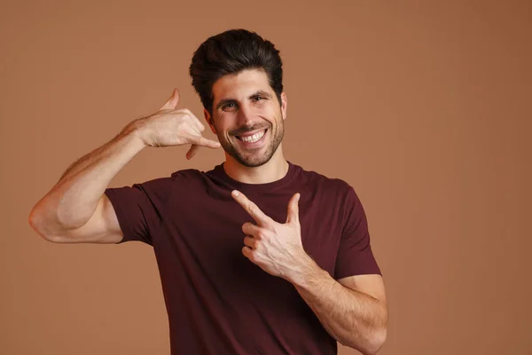 Happy Man Pointing Finger Upward While Showing Handset Gesture Isolated — Stock Photo, Image