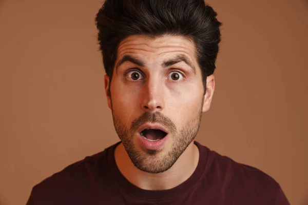 Shocked Unshaven Young Man Expressing Surprise Camera Isolated Beige Background — Stock Photo, Image