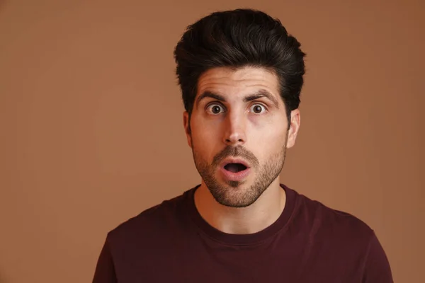 Shocked Unshaven Young Man Expressing Surprise Camera Isolated Beige Background — 图库照片