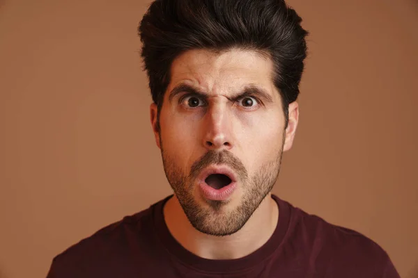 Displeased Unshaven Young Man Expressing Surprise Camera Isolated Beige Background — Stock Photo, Image