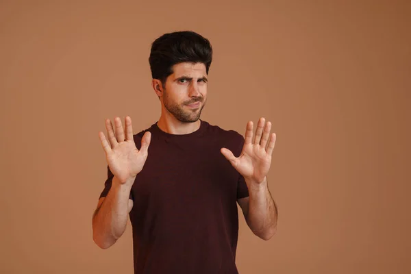 Displeased Unshaven Young Man Showing Stop Gesture Camera Isolated Beige — Stock Photo, Image